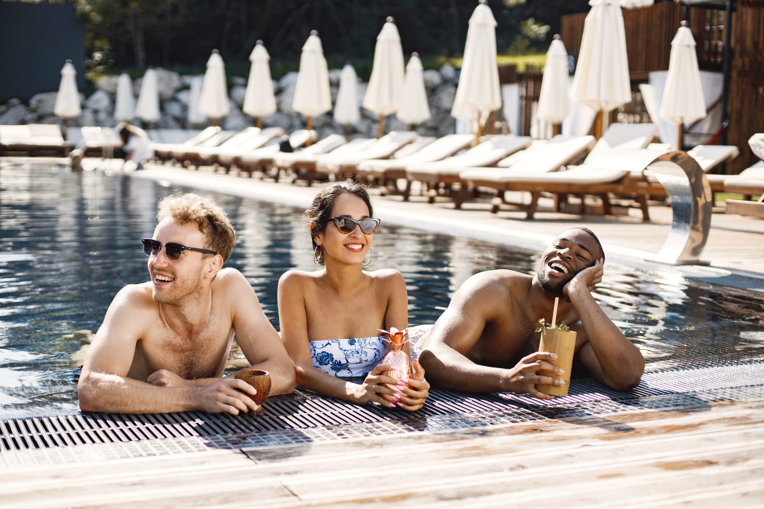 Adults relaxing by a luxury pool